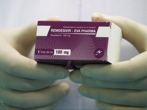 A lab technician holds the coronavirus disease treatment drug "Remdesivir" at Eva Pharma Facility in Cairo, Egypt, June 25, 2020.