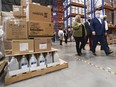 Ontario Premier Doug Ford, right, tours a warehouse where they ship personal protective equipment during the COVID-19 pandemic in Milton, Ont., on Wednesday, September 30, 2020.