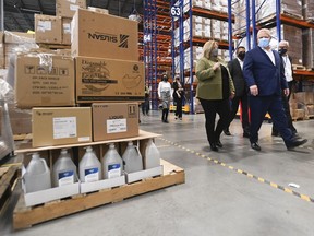Ontario Premier Doug Ford, right, tours a warehouse where they ship personal protective equipment during the COVID-19 pandemic in Milton, Ont., on Wednesday, September 30, 2020.