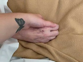 Shayla Costello holds the hand of her mother, Diane Costello of Windsor, in a photo shared on the day of Diane's death, Sept. 29, 2020.