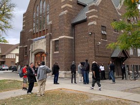 Visitors to the Downtown Mission at 664 Victoria Ave. in Windsor line up for a Thanksgiving meal on Oct. 12, 2020.