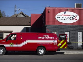 Fire investigators work at the scene of an early-morning fire at an auto shop at 1460 College Ave. on Thursday, Oct. 8, 2020.