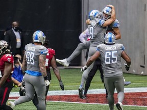 Detroit Lions quarterback Matthew Stafford and tight end T.J. Hockenson react after connecting on the game tying touchdown pass on the final play against the Atlanta Falcons during the second half at Mercedes-Benz Stadium.