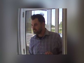 A surveillance camera image released by Windsor police of the suspect in a fraud case that was discovered in June 2020.