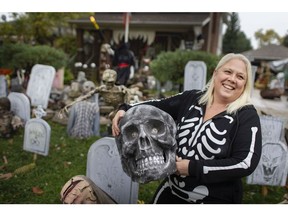 Nancy McDowall-Dunford stands in the middle of her impressive Halloween display on her front lawn on St. Mary's Blvd., Thursday, Oct. 22, 2020.