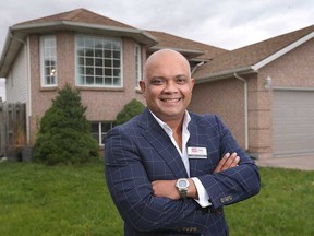 Shibu George, a realtor with Royal LePage, in front of a recently-sold home on Lounsborough Court in South Windsor on Oct. 15, 2020. A survey by Royal LePage has found Windsor home prices increased by 17 per cent in this fiscal year's third quarter.