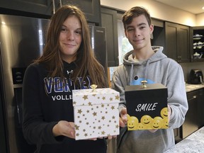 Hailey Charon, 15, and her brother Spencer Charron, 14, display  "Send A Smile" gift boxes at their Tecumseh home on Tuesday, Oct. 27, 2020. Their mother Kara Charron started the creative business and has been shipping the boxes all over Canada.