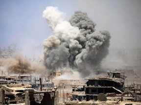 Smoke rises from buildings following a reported air strike on a rebel-held area in the southern Syrian city of Daraa, May 22, 2017.