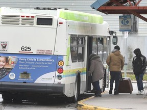 A Transit Windsor passenger boards a bus at the downtown terminal on Monday, October 19, 2020. Passengers remain restricted from using the front entry door due to pandemic protocols.