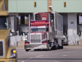Trucks cross the Ambassador Bridge, Tuesday, Oct. 20, 2020. The city has rejected  the latest attempt by the bridge owners to have dangerous goods allowed across the bridge.