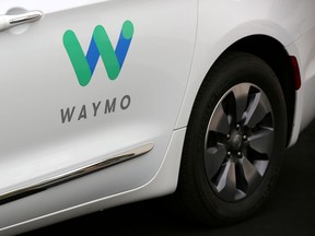 FILE PHOTO: A Waymo Chrysler Pacifica Hybrid self-driving vehicle is parked and displayed during a demonstration in Chandler, Arizona, November 29, 2018.