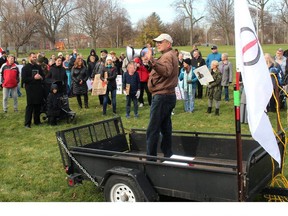 Paul Pinsonneault speaks at a rally protesting a bylaw that requires people to wear face masks. A march started in Tecumseh Park and continued through downtown Chatham on Saturday. (Ellwood Shreve/Postmedia Network)