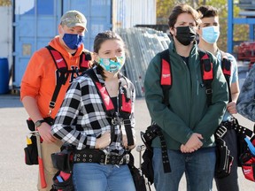 Cassidy Atkinson, centre,  Jacob Primeau, left, and 17 other high school students with the Greater Essex County District School Board listen to MPP Rick Nichols during a funding announcement for the Enhanced Construction Program at UBC Local 494 in Oldcastle November 12, 2020.