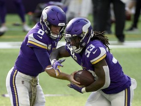 Kirk Cousins hands off to Dalvin Cook of the Minnesota Vikings during the first half of their game against the Detroit Lions at U.S. Bank Stadium on November 08, 2020 in Minneapolis, Minnesota.