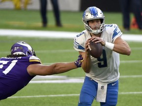 Detroit Lions' quarterback Matthew Stafford #9 is pressured by Hercules Mata'afa #51 of the Minnesota Vikings at U.S. Bank Stadium on Sunday.