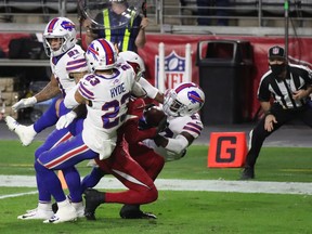 Wide receiver DeAndre Hopkins of the Arizona Cardinals catches the game winning 43-yard touchdown over Micah Hyde, Jordan Poyer and Tre'Davious White of the Buffalo Bills during the final moments of the NFL game at State Farm Stadium on November 15, 2020 in Glendale, Arizona. The Cardinals defeated the Bills 32-30.