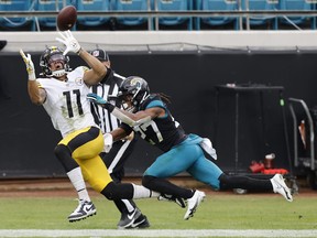 Chase Claypool of the Pittsburgh Steelers hauls in a touchdown catch against Jaguars' Chris Claybrooks defends during the first half at TIAA Bank Field on November 22, 2020 in Jacksonville.