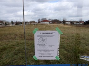 A notice about changes to the neighbourhood is posted inside a bus shelter on North Talbot near Sixth Concession Road Tuesday.