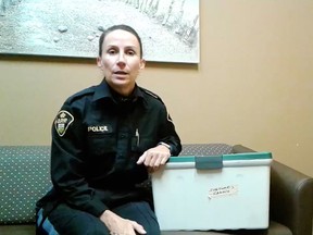 Essex County OPP Const. Amanda Allen shows off a beige storage tote with a green lid on Friday, Nov. 6, 2020. OPP believe the bin was stolen and want to return it to its rightful owner, but police don't know who that is.
