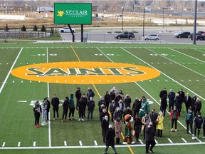 St. Clair College officials, athletes and guests gather on the football/soccer stadium field during the official opening of St. Clair College Sports Park on Tuesday.