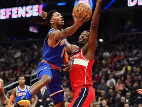 New York Knicks guard Elfrid Payton (6) shoots over Washington Wizards centre Ian Mahinmi (28) at Capital One Arena.