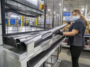 Production associate Alma Barahona inspects instrument panel beams at Canada Tubeform in Londo. The beams are destined to be installed in General Motors pick up trucks. (Derek Ruttan/The London Free Press)