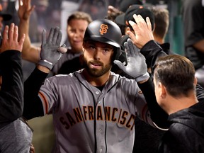 Mac Williamson of the San Francisco Giants is greeted in the dugout after a two run home in the fifth inning of the game against the Los Angeles Angels of Anaheim at Angel Stadium of Anaheim on April 20, 2018 in Anaheim, Calif.