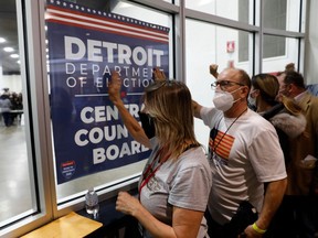 Supporters of US President Donald Trump bang on the glass and chant slogans outside the room where absentee ballots for the 2020 general election were counted at TCF Center on Nov. 4, 2020 in Detroit, Michigan.