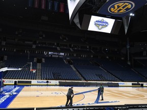 Workers at Bridgestone Arena remove signage and seating following the cancellation of the SEC mens basketball tournament due to concerns over the Covid 19 coronavirus.