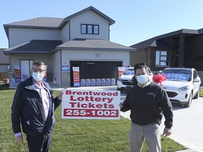 Mark Lennox, left, Interim Executive Director of the Brentwood Recovery Home and Jeff Sylvestre of Lakepoint Homes are shown during a press conference on Thursday, November 12, 2020 in Belle River. They are posing in front of the Brentwood Lottery Dream Home located on Summer Street in Belle River.