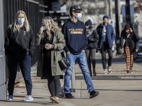People walk on Spring Garden Road in Halifax, on Sunday, Nov. 15, 2020. Travel is no longer the primary cause of all cases in Nova Scotia, a worrisome turn of events.