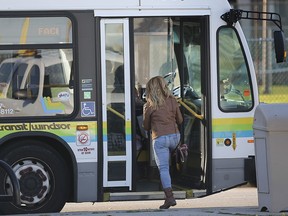 A Transit Windsor bus picks up a passenger at Riverdale Ave. and Riverside Dr. E. on Wednesday, November 4, 2020.