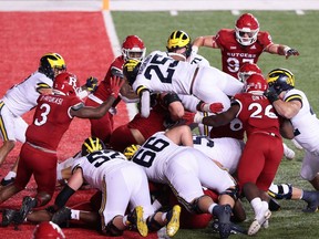 Michigan Wolverines running back Hassan Haskins scores on a touchdown run during the third overtime against the Rutgers Scarlet Knights at SHI Stadium.