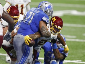 Nov 15, 2020; Detroit, Michigan, USA; Washington Football Team running back Antonio Gibson (24) reaches for a touchdown against Detroit Lions nose tackle Danny Shelton (71) and outside linebacker Jamie Collins (58) during the fourth quarter at Ford Field. Mandatory Credit: Raj Mehta-USA TODAY Sports