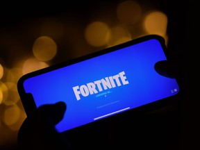This file illustration photo taken on Aug. 14, 2020 shows a person logging into Epic Games' Fortnite on their smartphone in Los Angeles.