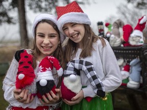 Savannah Howe, 10, left, and friend, Morgan Pueschel, 10, are pictured with the holiday gnomes they made and sold for charity, Monday, Nov. 30, 2020.