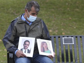 Hossein Bashiri holds a photo of his daughter Samira Bashiri and her husband Hamidreza Setareh Kokab, two of the five Windsorites who were killed in the shooting down of Ukrainian Flight PS752 on Jan. 8 in Tehran, during a ceremony on Thursday dedicating a collection of benches and trees in the victims' honour on the Windsor riverfront.