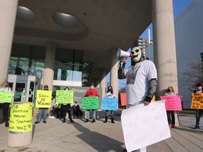 Protesters outside the Ontario court building in downtown Windsor call for the justice system to be less lenient with those who commit violent crime. Photographed Nov. 13, 2020.