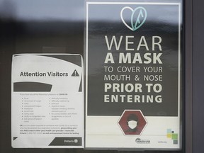 A sign warning customers that masks are required is shown on the door of a Windsor business on Nov. 27, 2020.