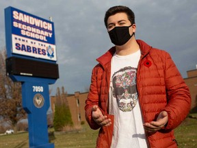 Sean O'Neil, 17, stands outside his high school, Sandwich Secondary School in LaSalle, on Nov. 5, 2020.