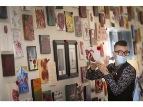 Local artist, Asaph Maurer, hangs a piece of art at a Poppy Art Campaign, organized by the Art Incubator and Coulter's Furniture, Saturday, Nov. 7, 2020.