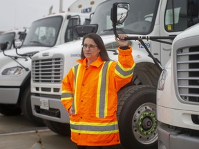 Anne-Marie Albidone, environmental services manager, is pictured with the fleet of trucks that will be used for the city's county recycling collection, Tuesday, Nov. 24, 2020.