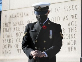 A naval reservist bows his head during the Remembrance Day ceremony at the Essex County War Memorial Cenotaph in downtown Windsor on Nov. 11, 2020.