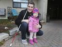 Ryan Hooey pictured with daughter Abigail, 1, near Tecumseh Mansion on Saturday, Nov. 14, 2020. Hooey lost his sight at the age of 27 due to diabetes and is calling on manufacturers to develop insulin pumps for blind people.
