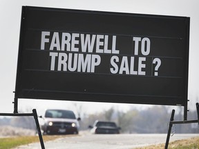 Cashing in on a lost cause? Some opportunistic marketing on a sign in front of an Amherstburg business is shown on Friday, Nov. 6, 2020, as vote counting continues across the border to determine who will lead the most powerful country in the world.