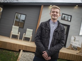 Clarke Gallie, co-owner of NC Capital, stands in front of a newly built Tiny house in the rear of 773 Assumption Ave., Friday, Nov. 13, 2020.