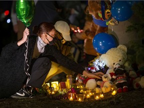 Mourners place candles and other items in recognition of the 7-year-old boy killed in a hit-and-run incident at Jefferson Boulevard and Haig Avenue in Windsor. Photographed Nov. 20, 2020.