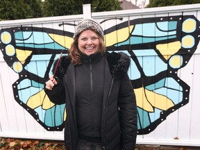 Local artist Debbie Kay poses in front of her "Show Us Your Wings" mural on Sunday, November 22, 2020, in an alley near Victoria and Pine in Windsor. The piece is a fundraiser for the Brain Injury Association of Windsor & Essex County.