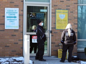 Security guards monitor arrivals and departures at the COVID-19 assessement centre at Ouellette Avenue campus of Windsor Regional Hospital Thursday.
