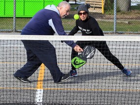 Silvio Civitarese, left, hits a nice backhand during a friendly pickleball game with playing partner Joanne Laforest, right, in East Riverside Thursday.